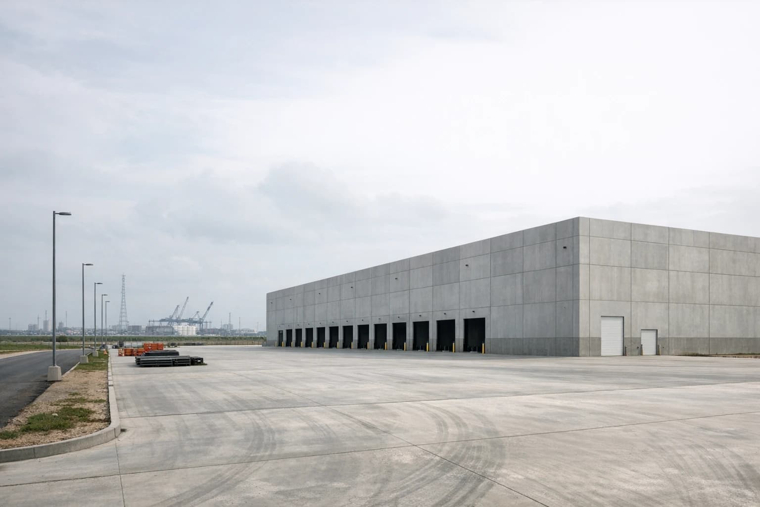 Large coastal industrial shell and paved yard near Galveston logistics corridors.